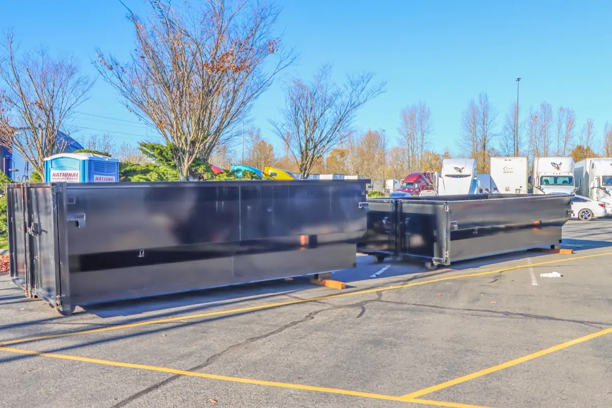 Professional dumpster rental service with roll-off container on residential driveway in Spring Garden